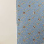 Lampasso fabric with light blue background and woven floral pattern in classic style. Flowers in shades of red, orange and yellow with green leaves, perfect for curtains, pillows, upholstery and shabby chic decorations. Elegant and vibrant print for decorating with personality. Made in Italy.