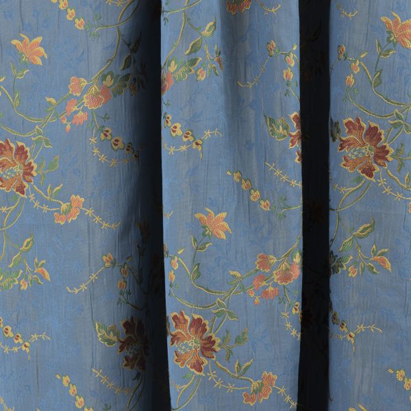 Lampasso fabric with light blue background and woven floral pattern in classic style. Flowers in shades of red, orange and yellow with green leaves, perfect for curtains, pillows, upholstery and shabby chic decorations. Elegant and vibrant print for decorating with personality. Made in Italy.