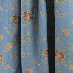 Lampasso fabric with light blue background and woven floral pattern in classic style. Flowers in shades of red, orange and yellow with green leaves, perfect for curtains, pillows, upholstery and shabby chic decorations. Elegant and vibrant print for decorating with personality. Made in Italy.