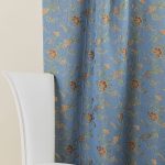 Lampasso fabric with light blue background and woven floral pattern in classic style. Flowers in shades of red, orange and yellow with green leaves, perfect for curtains, pillows, upholstery and shabby chic decorations. Elegant and vibrant print for decorating with personality. Made in Italy.