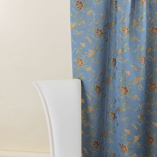 Lampasso fabric with light blue background and woven floral pattern in classic style. Flowers in shades of red, orange and yellow with green leaves, perfect for curtains, pillows, upholstery and shabby chic decorations. Elegant and vibrant print for decorating with personality. Made in Italy.
