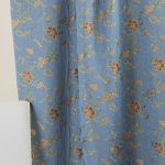 Lampasso fabric with light blue background and woven floral pattern in classic style. Flowers in shades of red, orange and yellow with green leaves, perfect for curtains, pillows, upholstery and shabby chic decorations. Elegant and vibrant print for decorating with personality. Made in Italy.